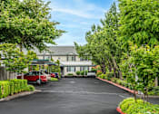 Thumbnail 23 of 37 - A parking lot in front of a building with cars parked.at Vancouver Mall Apartments, Vancouver, WA ? 