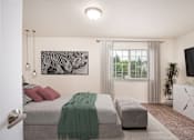 Thumbnail 14 of 37 - A bedroom with a bed, a couch, and a television.at Vancouver Mall Apartments, Vancouver, 98662 ? 
