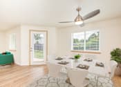 Thumbnail 2 of 37 - A dining room with a table set for six and a ceiling fan.at Vancouver Mall Apartments, Vancouver Washington
