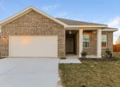 Thumbnail 3 of 32 - a brick house with a white garage door