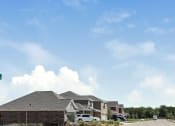 Thumbnail 3 of 23 - A row of houses with a car parked in front of them.