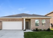 Thumbnail 2 of 32 - a brick house with a white garage door