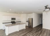 Thumbnail 22 of 32 - a kitchen with white cabinets and a stainless steel refrigerator