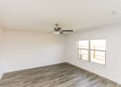 Thumbnail 20 of 33 - an empty room with a ceiling fan and a window