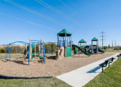Thumbnail 4 of 33 - A playground with a green slide and a blue swing set.