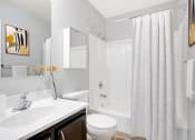 Thumbnail 10 of 14 - Stratford Wood Apartments and Townhomes in Minnetonka, MN Photo of a bathroom with a sink and a toilet and a shower
