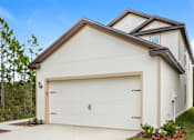Thumbnail 32 of 56 - A modern house with a white garage door.