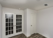 Thumbnail 10 of 33 - an empty room with two doors and a window