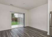 Thumbnail 32 of 32 - Three BR Homes for Rent in Haslet TX - Willow Springs - A Vacant Living Room With Wood-Style Flooring And A Sliding Glass Door Leading Outside
