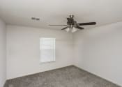 Thumbnail 11 of 33 - an empty room with a ceiling fan and a window