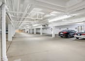 Thumbnail 13 of 14 - Stratford Wood Apartments and Townhomes in Minnetonka, MN Photo of a parking garage with cars parked in it