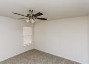 Thumbnail 25 of 33 - an empty room with a ceiling fan and a window