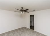 Thumbnail 26 of 33 - 3 Bedroom Homes for rent in Newark TX - Chisholm Springs - Carpeted Bedroom with White Walls, Carpeted Flooring, a Ceiling Fan, and an Attached Bathroom