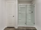 Thumbnail 14 of 33 - a walk in shower in a room with a white door