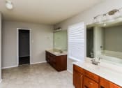 Thumbnail 27 of 33 - an empty bathroom with a large mirror and two sinks