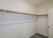 Thumbnail 11 of 32 - an empty closet in an empty room with white walls and a white door