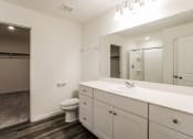 Thumbnail 5 of 32 - a bathroom with a large mirror and a sink and a toilet