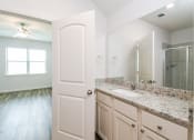 Thumbnail 5 of 11 - 3 Bedroom Single Family Homes for rent in Crowley TX- Lasater Ranch - An interior shot of the bathroom, featuring a sink, mirror, and a shower