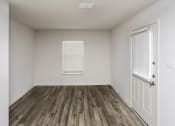 Thumbnail 15 of 33 - an empty room with wooden floors and white walls and a window