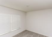Thumbnail 30 of 33 - an empty room with a large window and a carpet