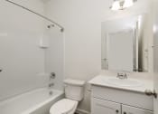 Thumbnail 30 of 32 - Four BR Homes for Rent in Haslet TX - Willow Springs - A Bright Bathroom With A Single Sink Vanity, A Toilet, And A Shower/Tub Combo