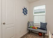Thumbnail 20 of 56 - A small room with a bench and a ball on the floor.