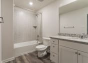 Thumbnail 14 of 23 - a bathroom with a toilet and a tub and a sink