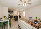 Thumbnail 17 of 56 - A well-lit, modern kitchen and dining area with a white ceiling fan.