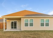 Thumbnail 10 of 32 - Pet Friendly Homes in Haslet TX - Willow Springs - Tan Home Exterior, with White Trim, a Sliding Glass Door, a Porch, and a Grassy Lawn