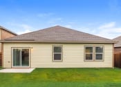 Thumbnail 29 of 32 - the front of a house with a yard and grass