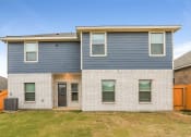 Thumbnail 15 of 23 - A modern two-story house with a grey exterior and white brick walls.