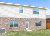 Thumbnail 16 of 23 - A house with a brick wall and a white siding wall.
