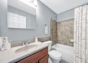 Thumbnail 5 of 40 - A bathroom with a sink, toilet, and bathtub.