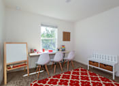Thumbnail 14 of 56 - A white room with a red rug and a white crib.