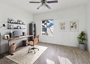 Thumbnail 9 of 19 - Affordable Apartments in Austin, TX for Rent- Huntington Meadows-  A room with a desk, chair, and a ceiling fan.