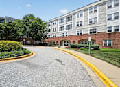 Thumbnail 29 of 32 - A street view of a residential area with apartment buildings.