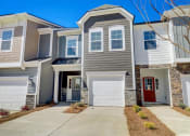 Thumbnail 1 of 20 - a house with a red door and gray siding