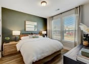 Thumbnail 20 of 56 -  Denton, TX Rental Homes - Carmel Villas - Spacious Bedroom With Two Large Windows For Natural Sunlight And Wood Vinyl Plank Flooring