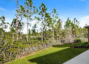 Thumbnail 31 of 56 - A house with a white pathway leading to it and a green lawn in front.