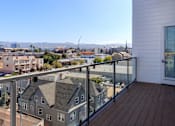 Thumbnail 4 of 20 - A balcony with a view of a cityscape.