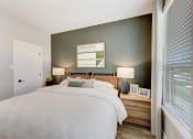 Thumbnail 19 of 56 - a bedroom with a bed and a window