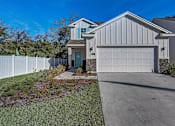 Thumbnail 15 of 21 - a home with a white fence and blue sky in the background