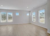 Thumbnail 16 of 19 - an empty living room with a hardwood floor