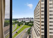 Thumbnail 7 of 66 - A view from a window of a highway and buildings.