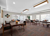 Thumbnail 21 of 32 - A dining room with a long table and chairs.