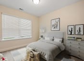 Thumbnail 8 of 28 - Omnia at Richmond Hill Townhomes in Georgia photo of a bedroom with a bed and a large window