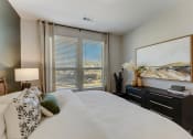 Thumbnail 17 of 56 - a bedroom with a large window and a large bed