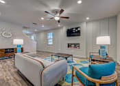 Thumbnail 11 of 21 - a living room with a fireplace and a ceiling fan