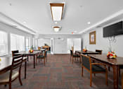 Thumbnail 22 of 32 - A dining room with wooden tables and chairs.