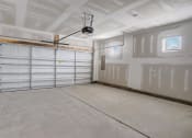 Thumbnail 18 of 19 - a large garage with white walls and a ceiling with a track light
